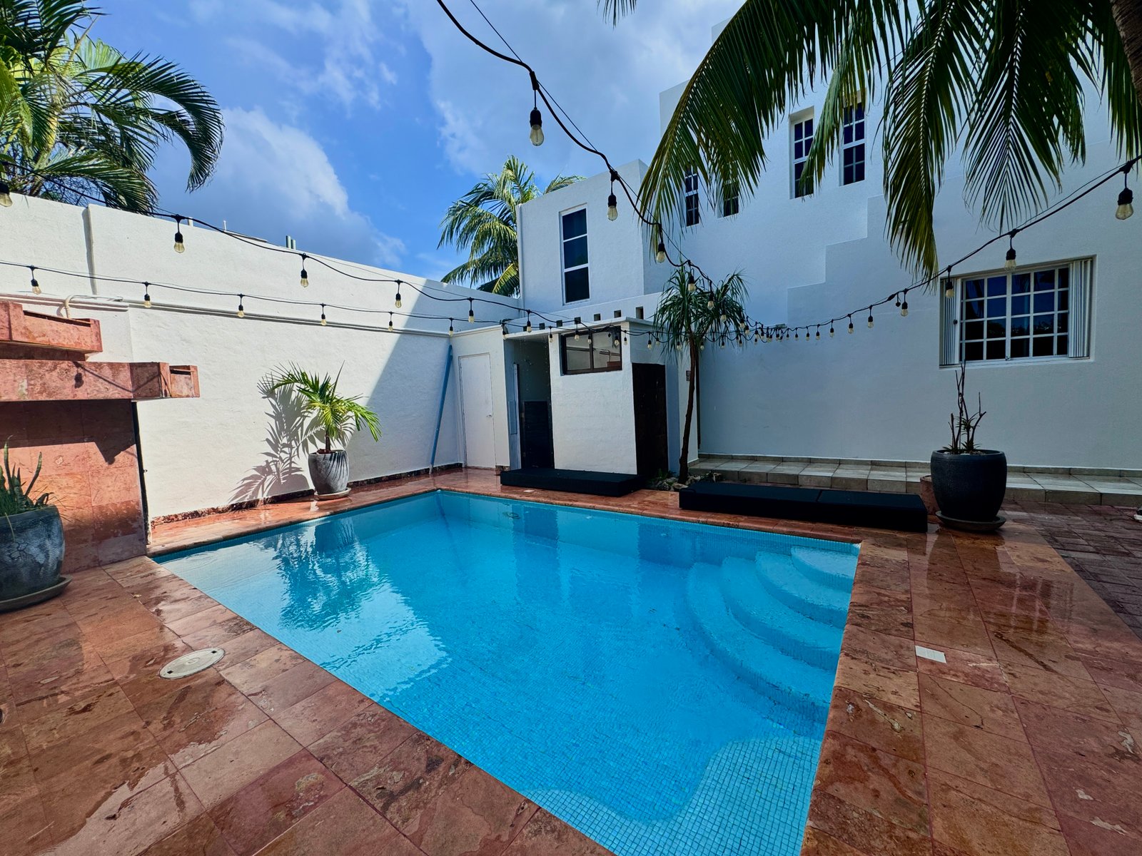 Inviting swimming pool at Casa 51 surrounded by comfortable lounge areas