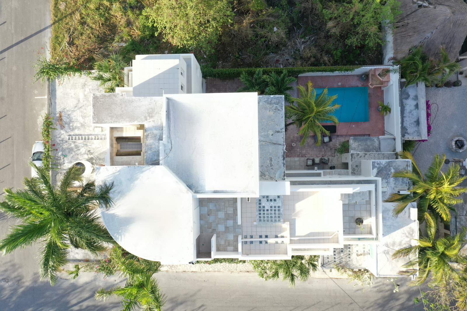 Panoramic aerial view of Casa 51's private pool and tropical landscaping